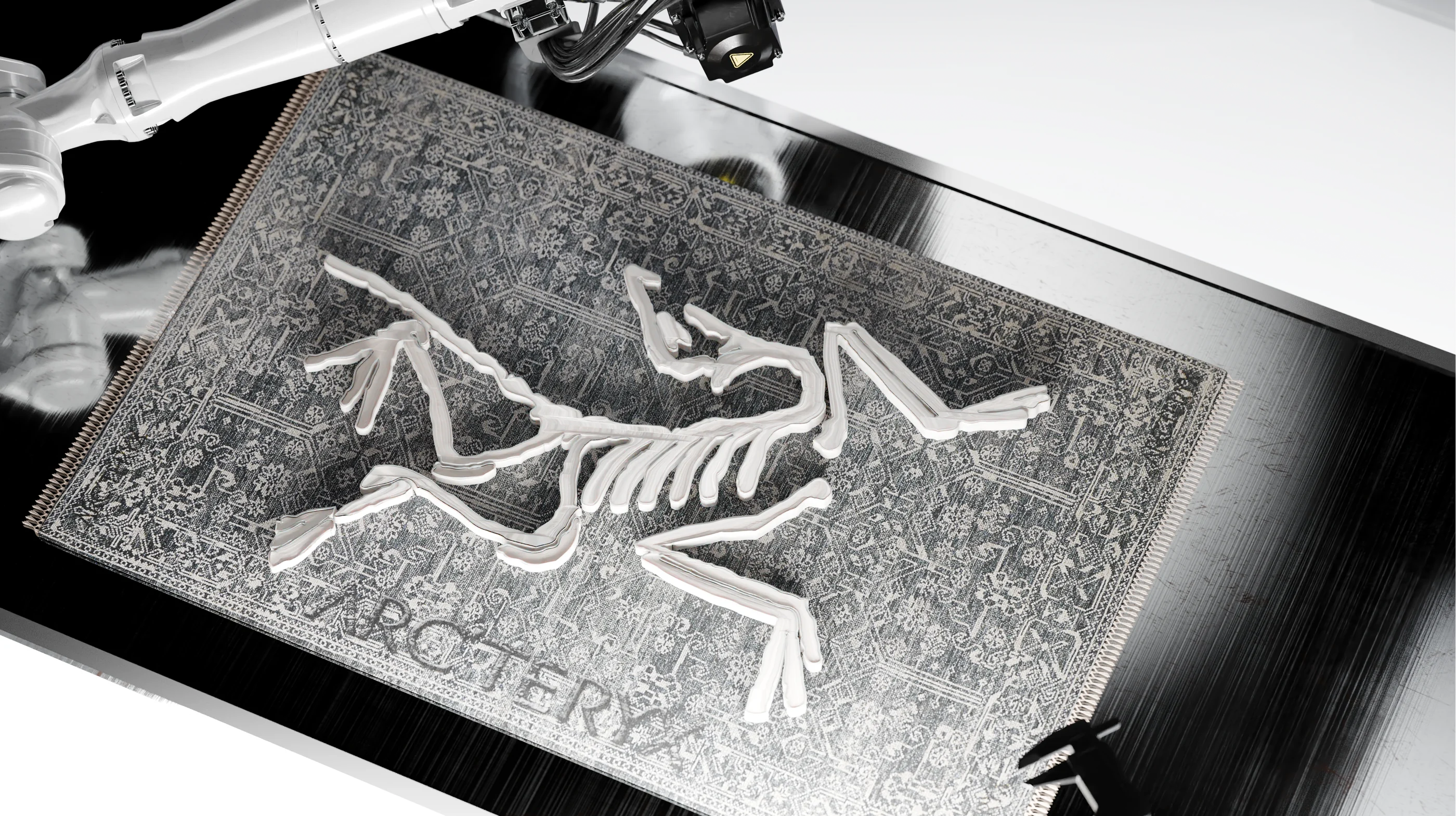 Metallic Arc’teryx bird plate beneath robotic arms