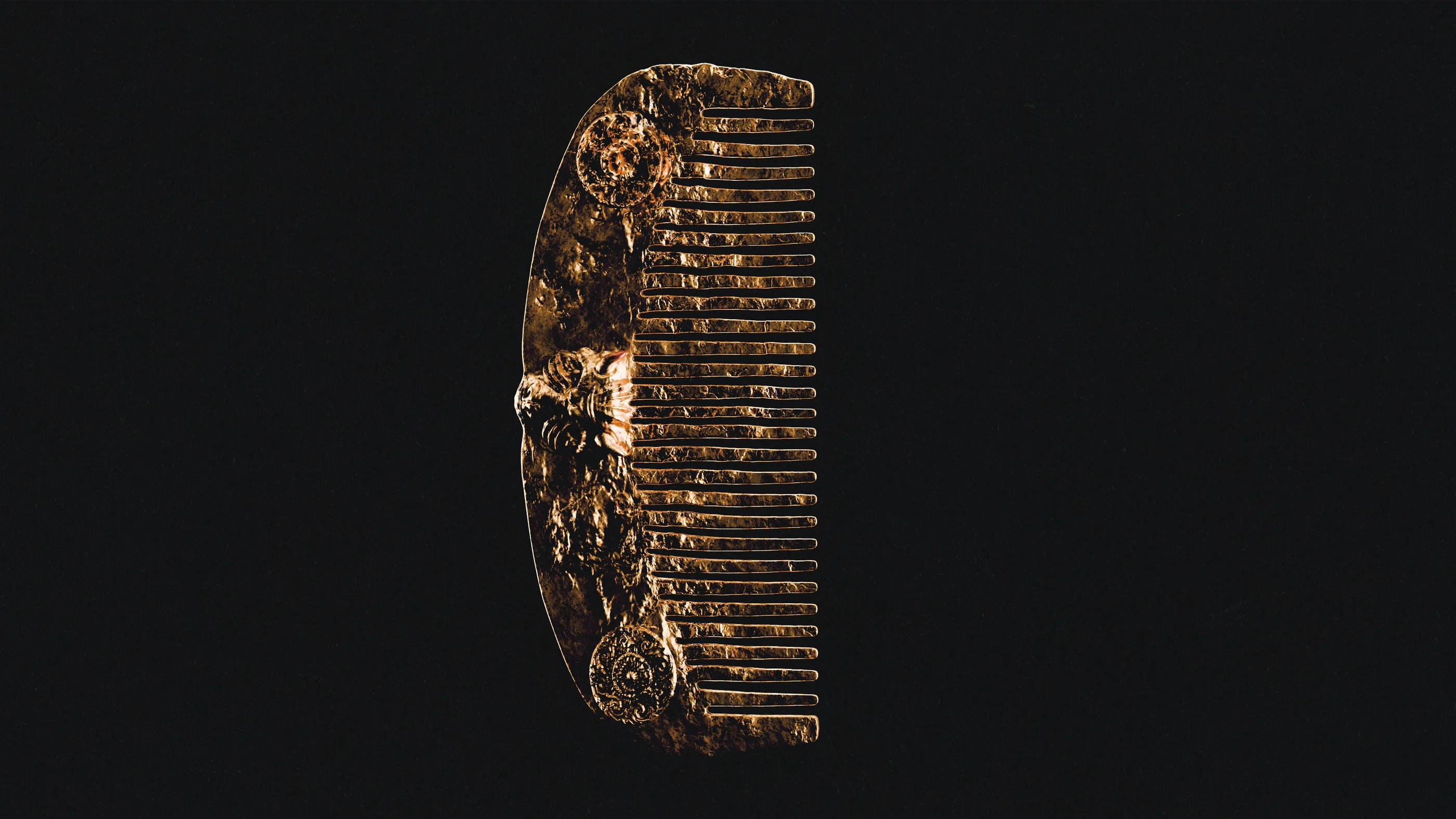Ornate gold comb against a dark background