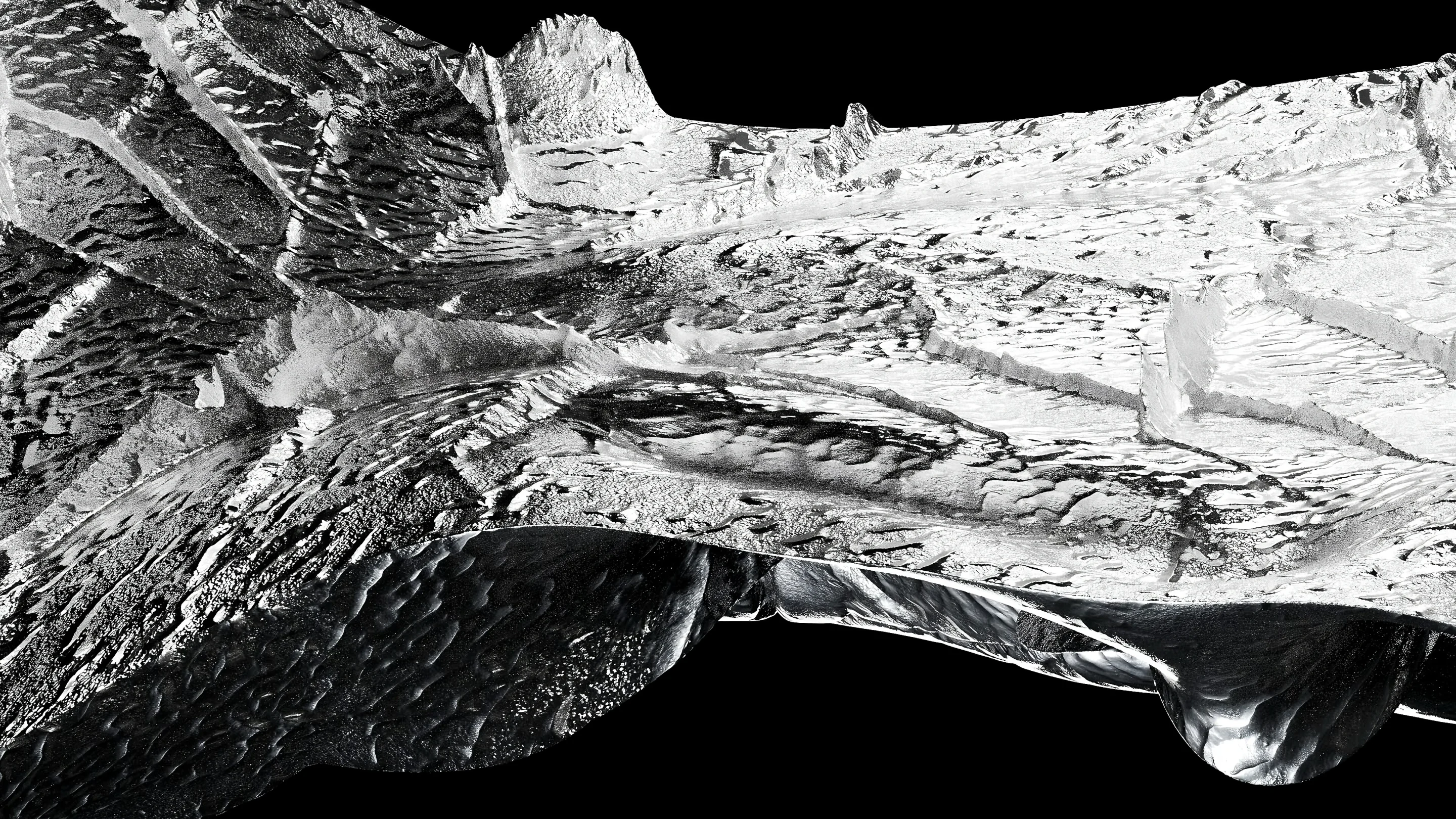 Reflective silver surface with sculpted ridges and rough textures against black